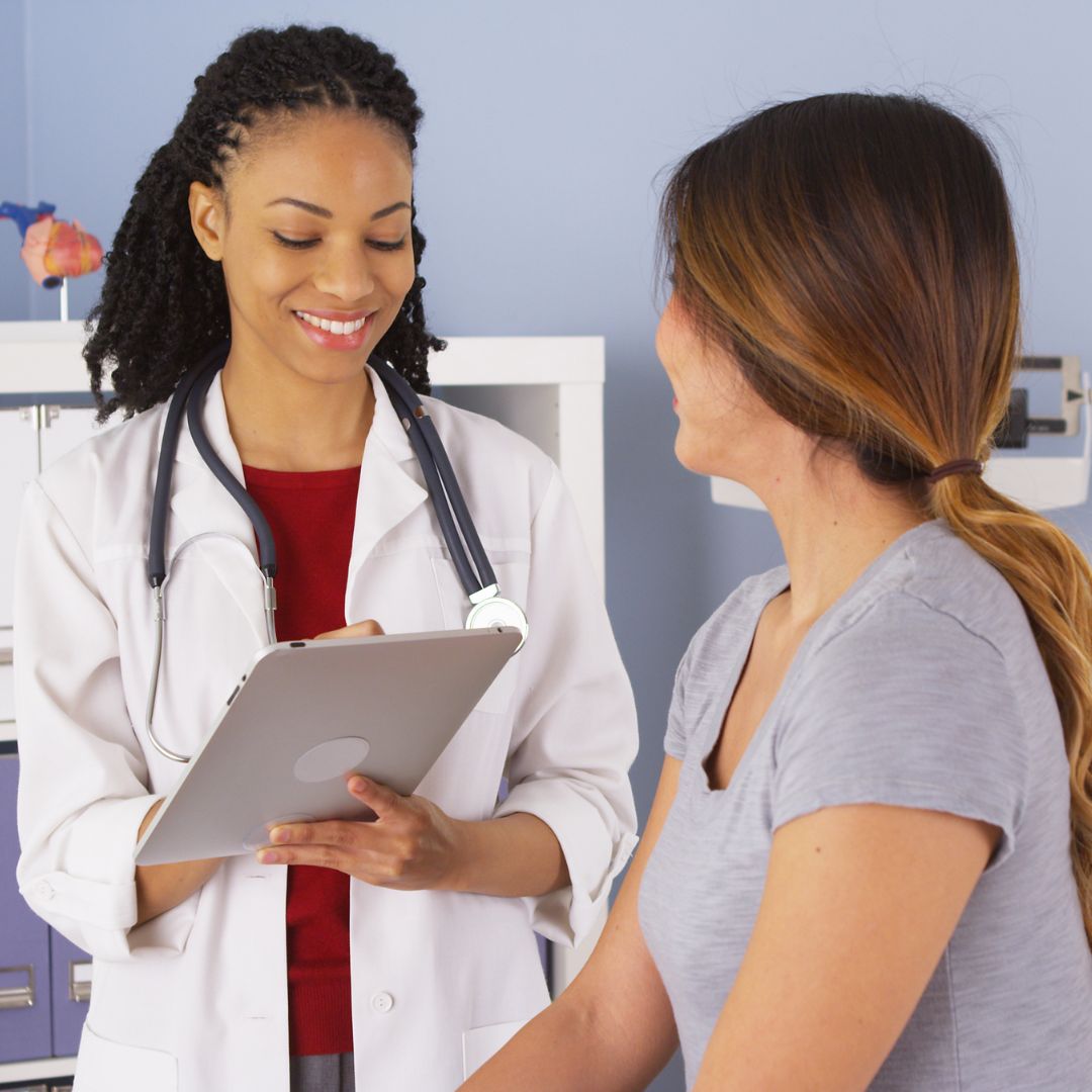 female doctor speaking with female patient